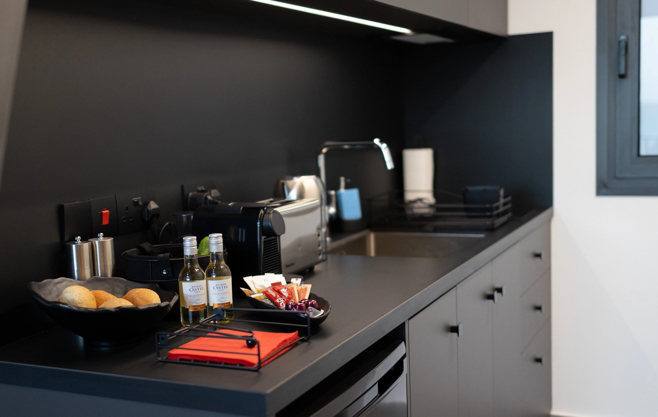 NOE Suites kitchenette with Nespresso coffee machine, electric kettle, toaster and refrigerator