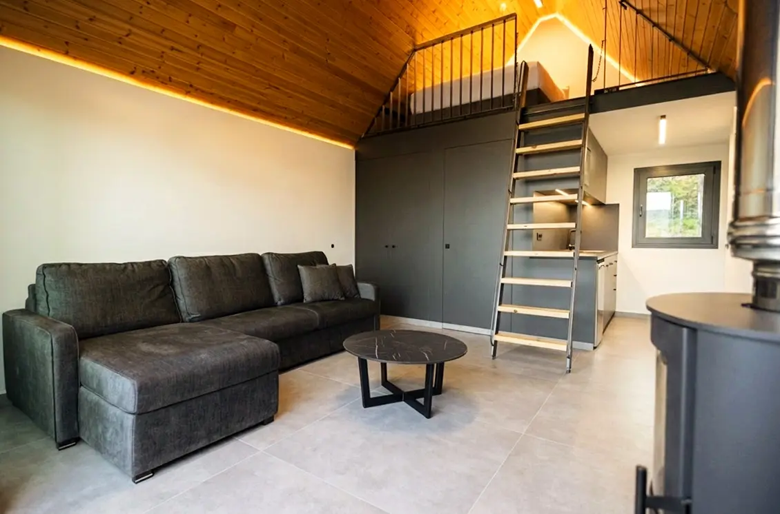 Wide view of a two-level NOE suite with mezzanine and terrace beyond
