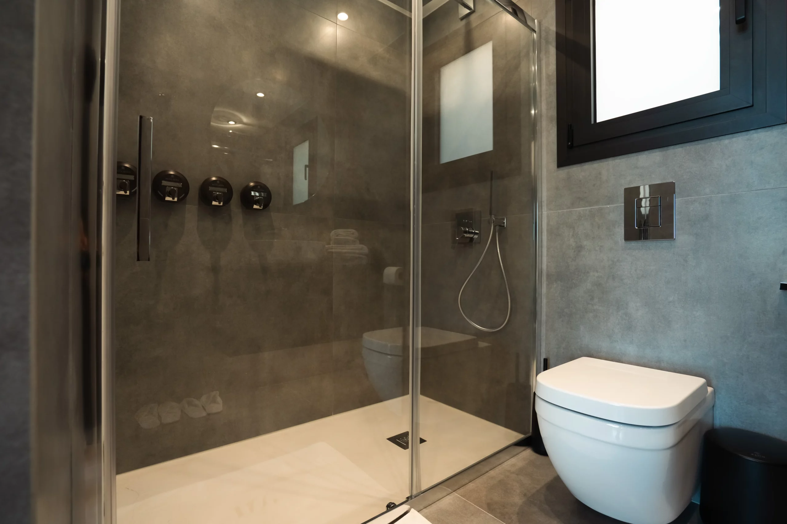 Walk-in shower inside a bathroom at NOE Suites