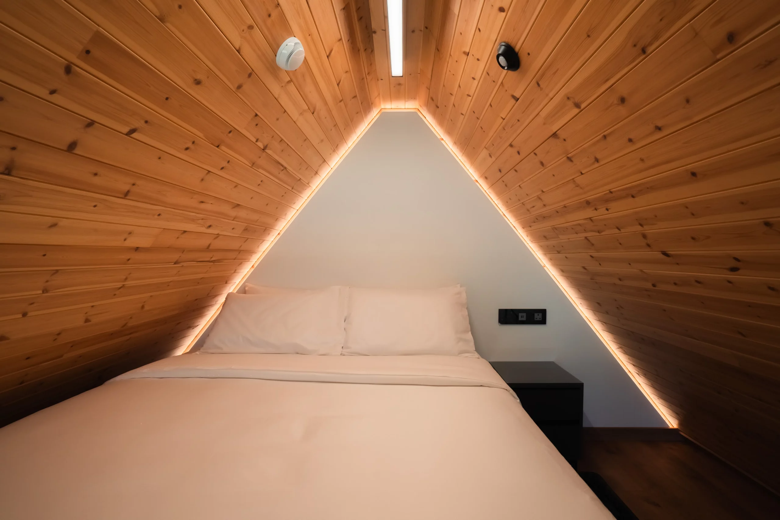 Comfortable sleeping area on the upper level of a NOE suite