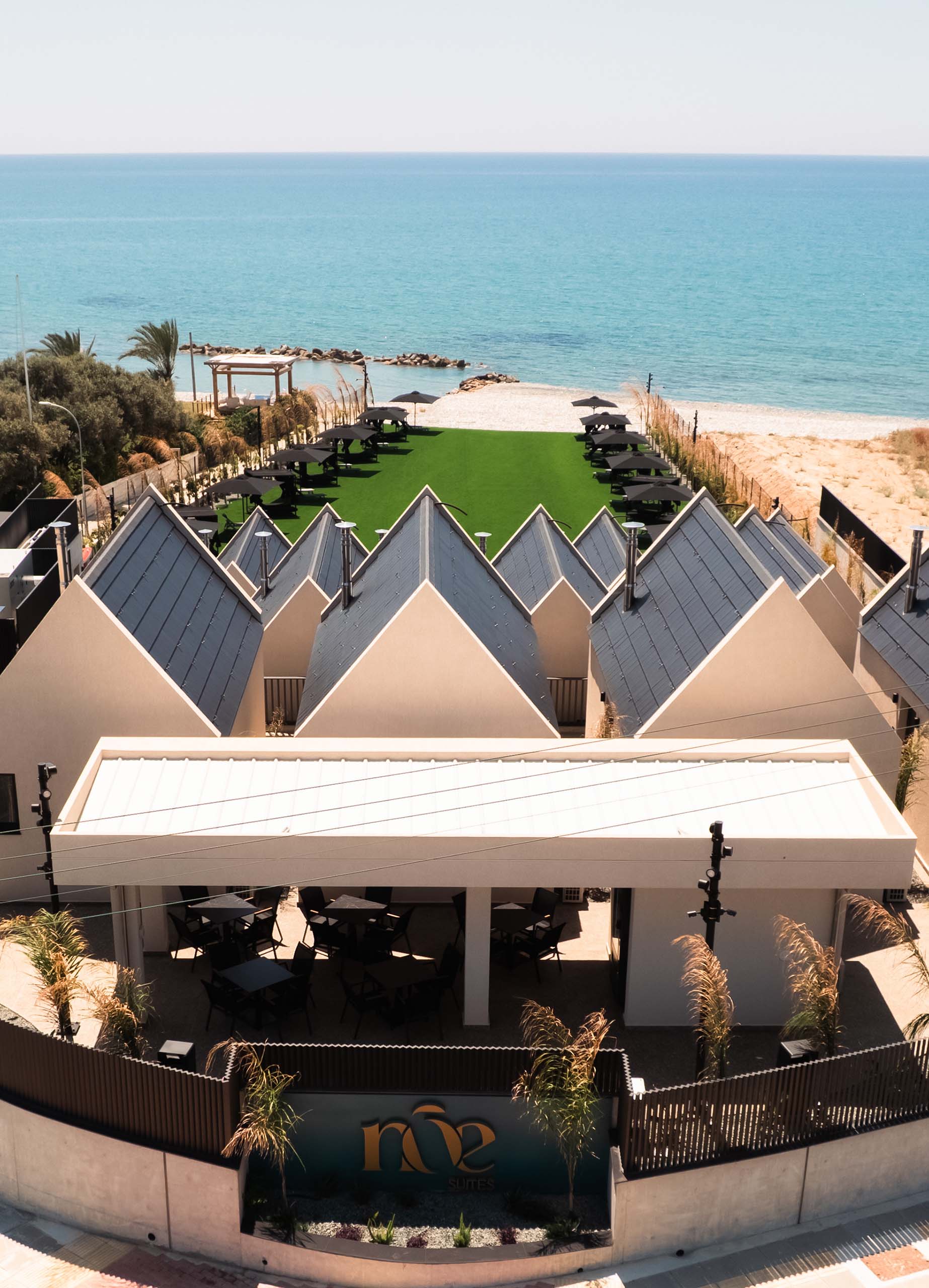 Aerial view of NOE Suites and its seaside grounds in Agios Theodoros, Cyprus.